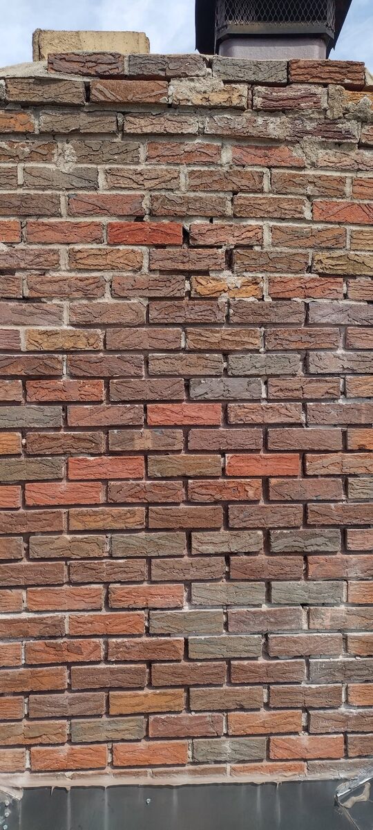 Washed-out mortar joints on an old Omaha chimney before repair