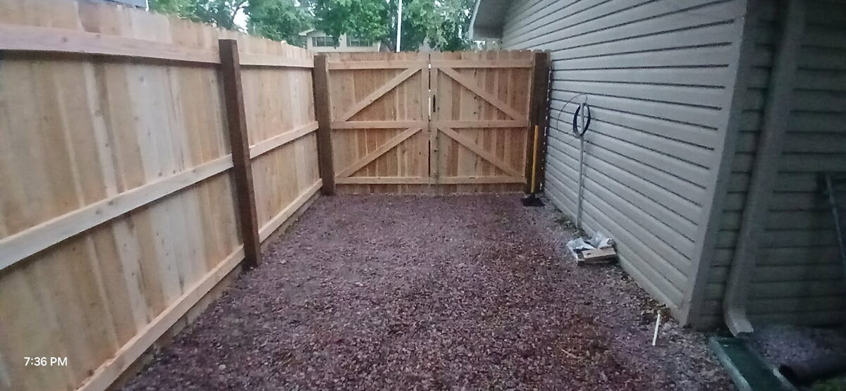 New wood privacy fence and gate installed along an Omaha home