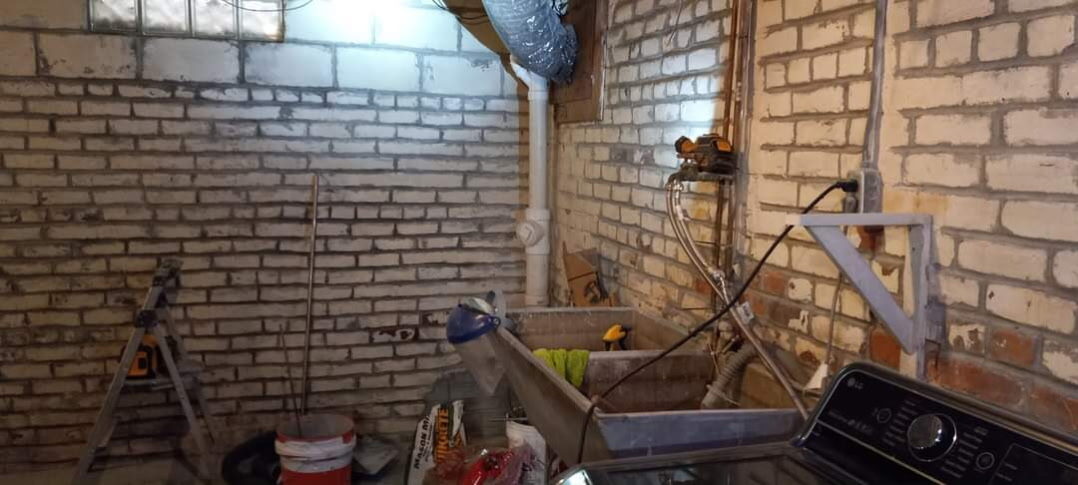 Deteriorated basement brick foundation wall in an Omaha home before repair