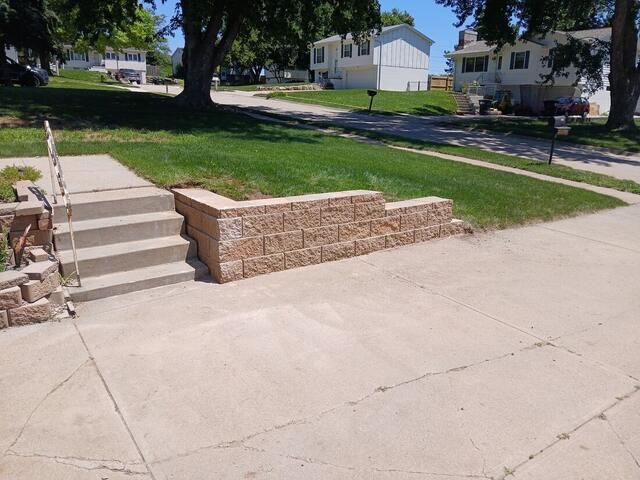 Retaining wall with new concrete steps and sidewalk