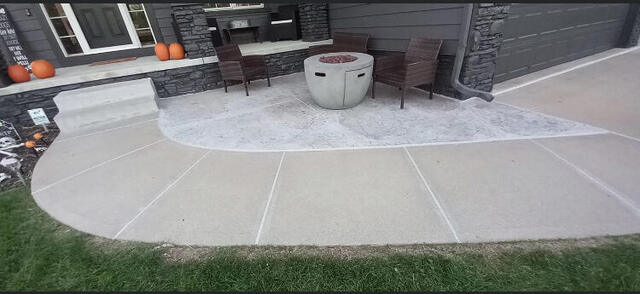 Stamped concrete patio with clean border behind a home
