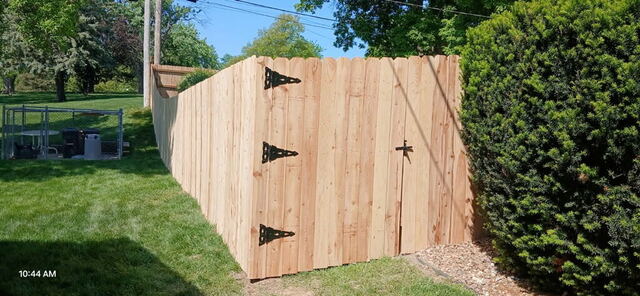 Finished cedar privacy fence with double gate in Omaha