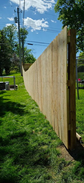 Long new cedar privacy fence run in an Omaha backyard