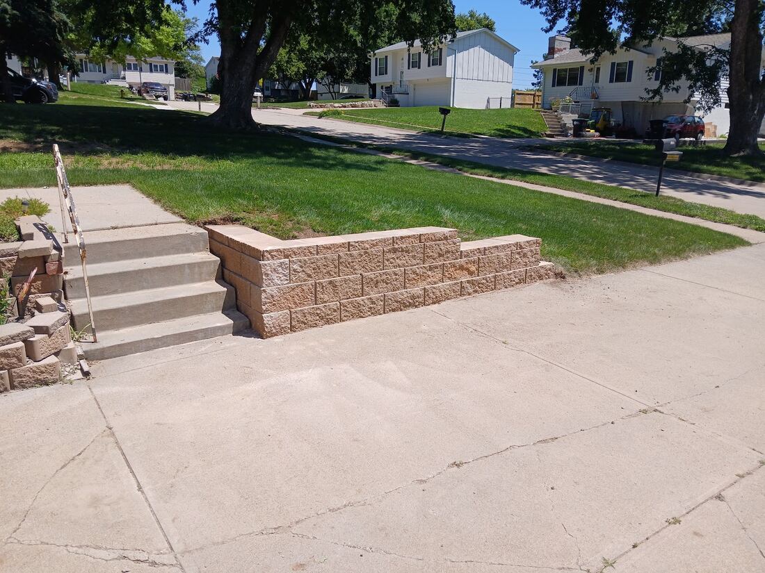 Retaining wall with new concrete steps and sidewalk in Omaha