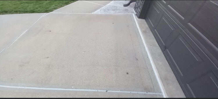 Driveway expansion joints cleaned and freshly caulked in Omaha