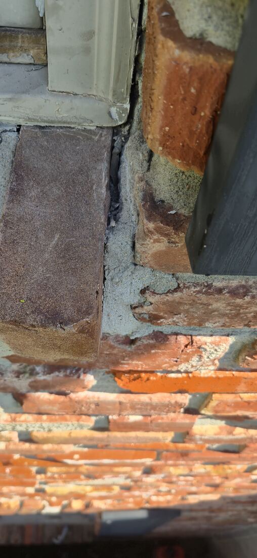 Close-up of deteriorated mortar joints and damaged brick on an Omaha home, before repair